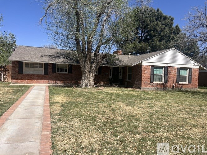 A house with a red brick exterior and a grey roof.