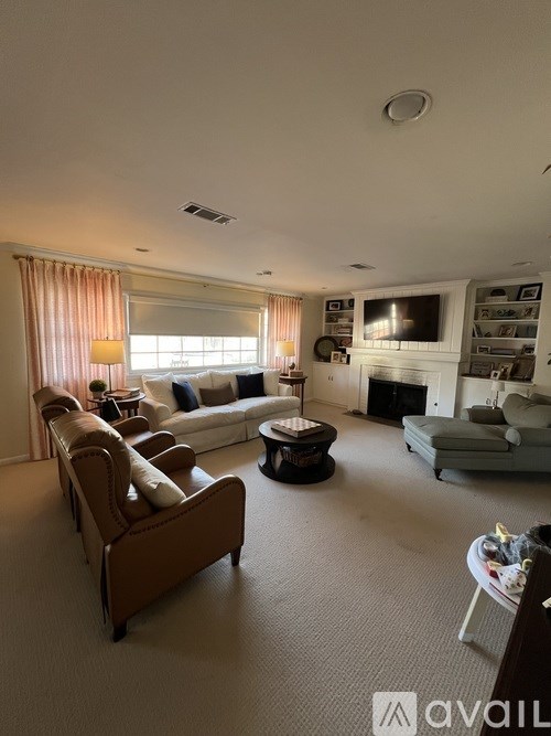 A living room with a brown sofa and a television.