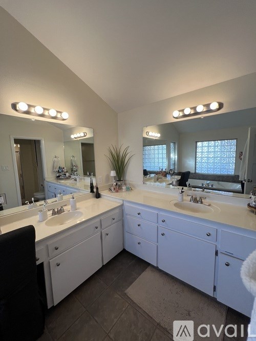 A bathroom with two sinks and a large mirror.