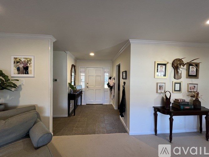A living room with a grey couch and a wooden table.