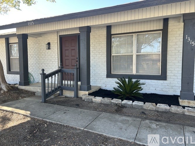 A house with a brown door and a window is for sale.