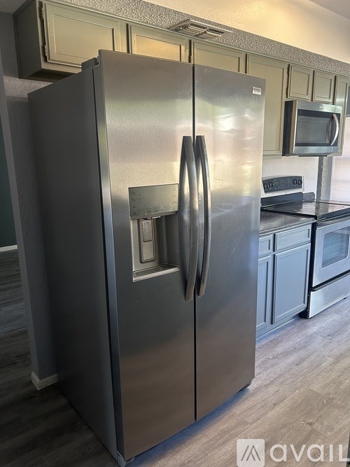 A stainless steel refrigerator with a water and ice dispenser in the door.
