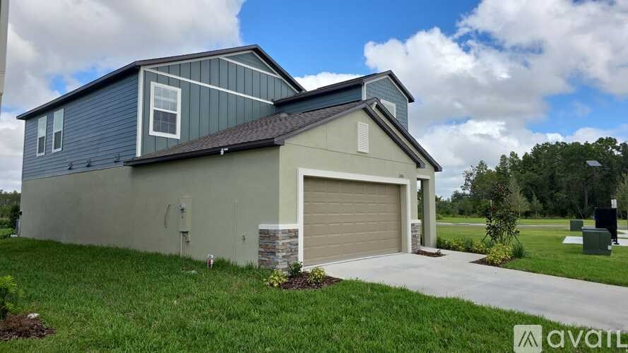 A house with a garage and a driveway in front.