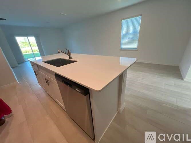 A modern kitchen with a large island and a dishwasher.