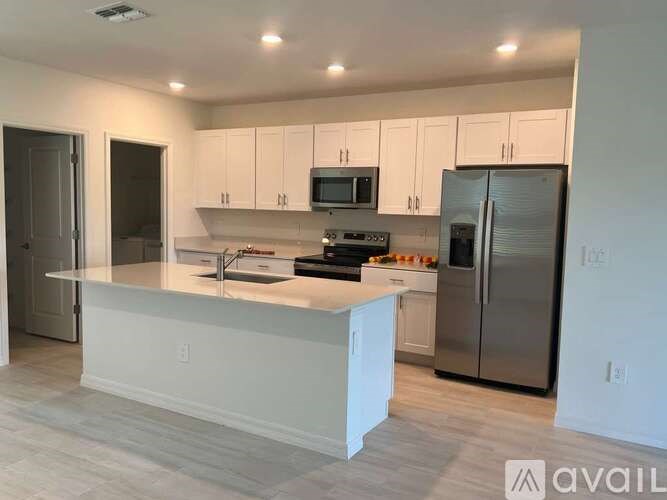 A kitchen with white cabinets and stainless steel appliances.