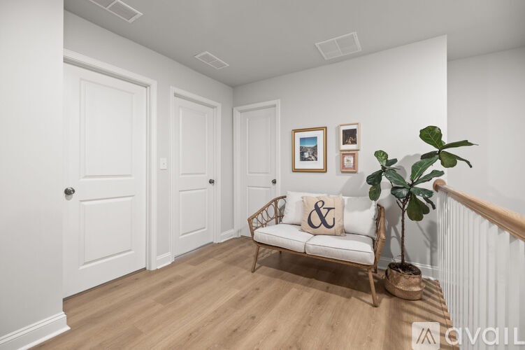 A room with a white couch and a wooden floor.