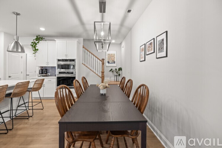A dining room with a long table and chairs.