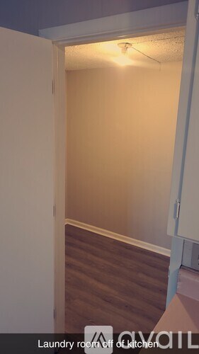 A laundry room off of a kitchen.