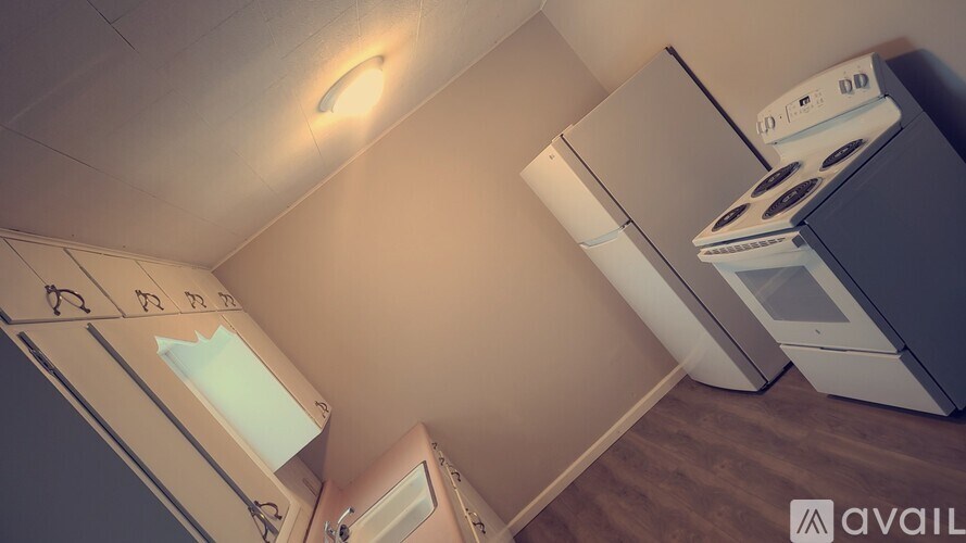 A kitchen with a white oven and a white fridge.