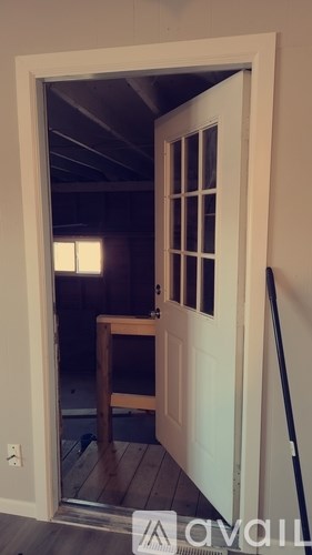 A white door with a glass window and a wooden frame.