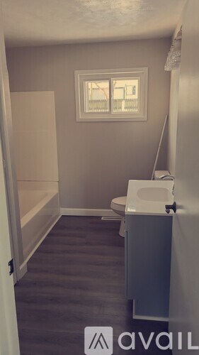 A small bathroom with a toilet and a window.