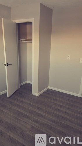 A room with a door and a wall socket.