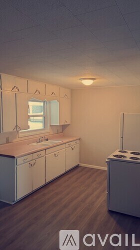 A kitchen with white cabinets and a stove top oven.