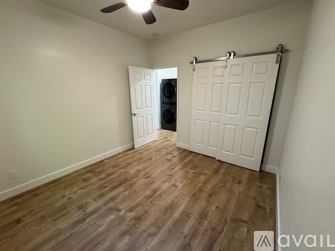 A room with a sliding door and a ceiling fan.