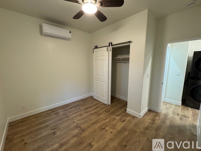 A room with a ceiling fan and a sliding door.