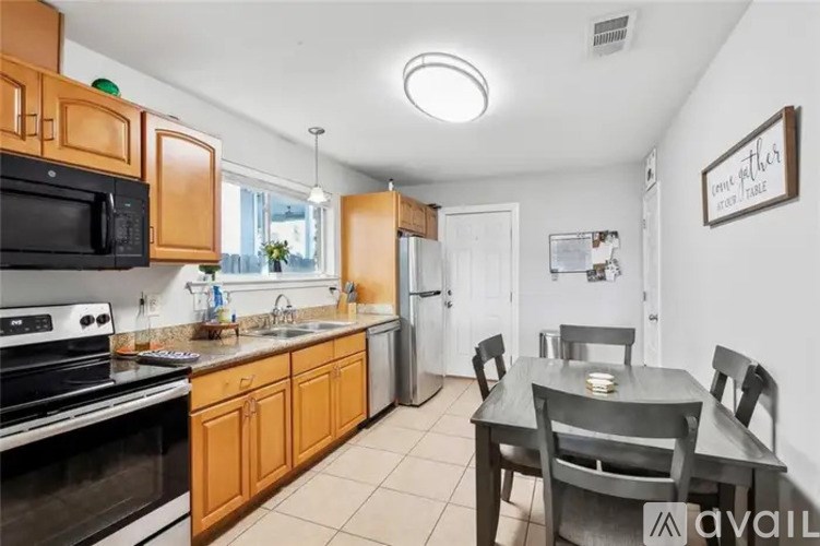 A kitchen with wooden cabinets and black appliances.