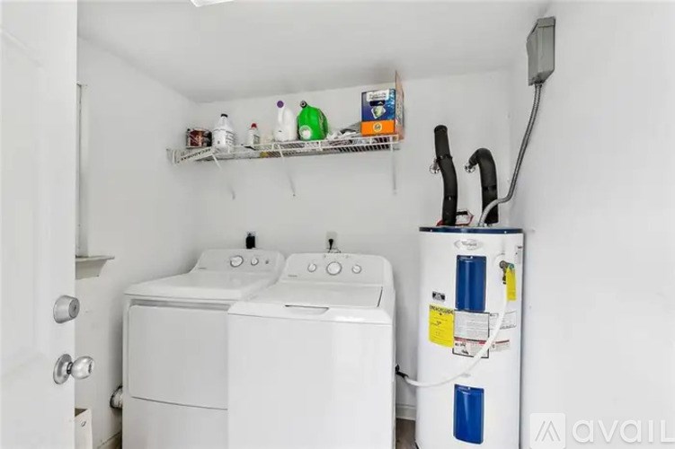 A small laundry room with a washer and dryer.
