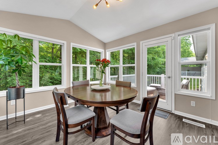 A dining room with a round table and chairs.