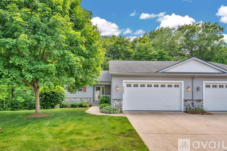 A house with a tree in front of it.