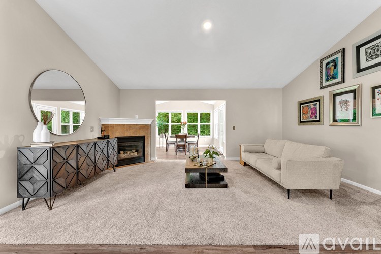 A living room with a fireplace and a mirror on the wall.