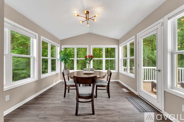 A dining room with a table and chairs and a chandelier.