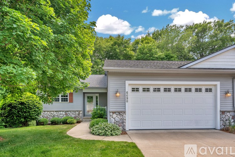 A house with a white garage door is for sale.