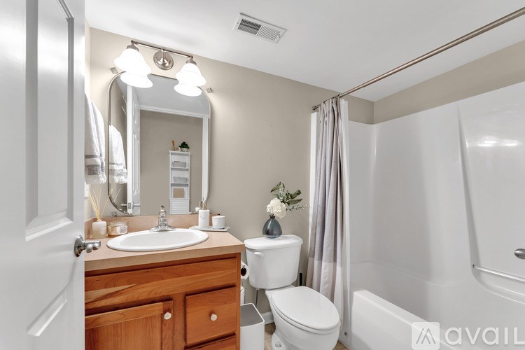 A bathroom with a sink, toilet, and bathtub.