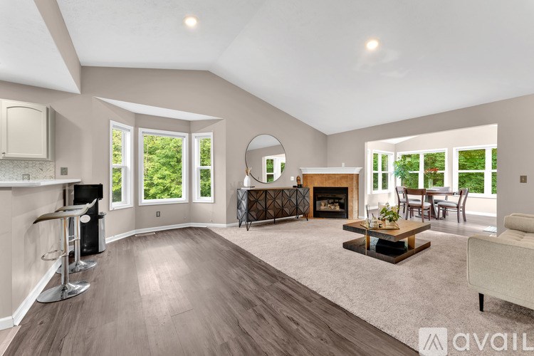 A spacious living room with a fireplace and a bar area.
