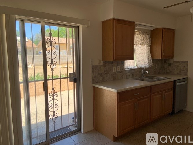 A kitchen with wooden cabinets and a glass door.