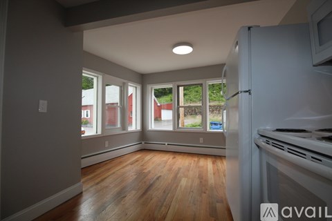 A kitchen with a refrigerator, stove, and oven.