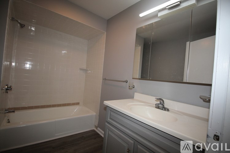 A bathroom with a white tub and sink.