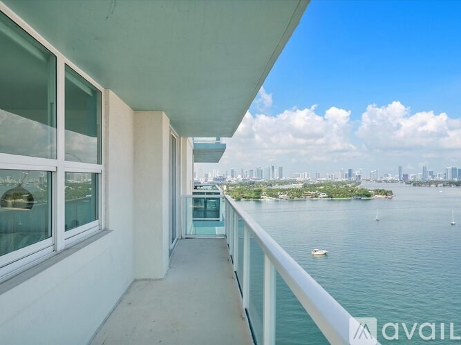 A balcony with a view of the city and water.