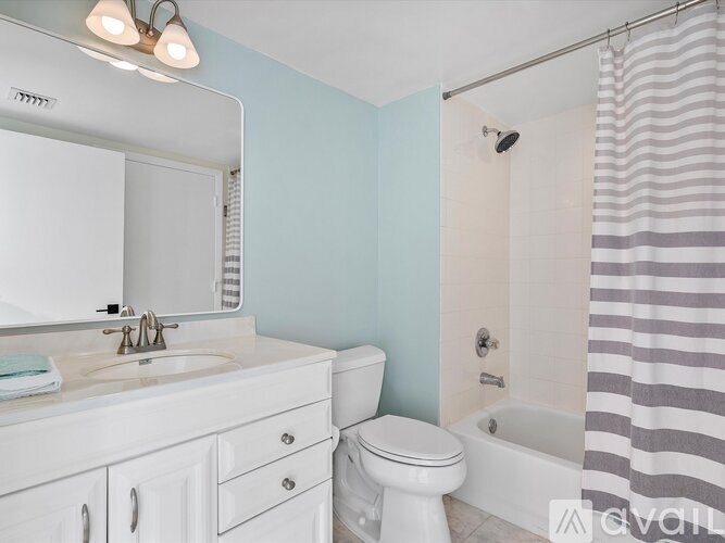 A white bathroom with a sink, toilet, and bathtub.