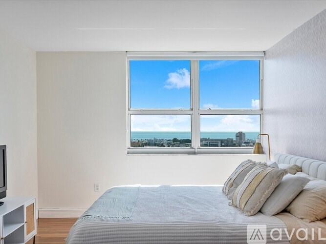 A bedroom with a large bed and a television.