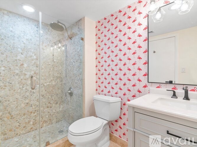 A bathroom with a toilet, sink, and shower.