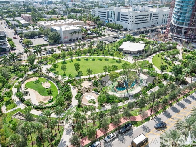 A large green park with a circular walking path in the middle.