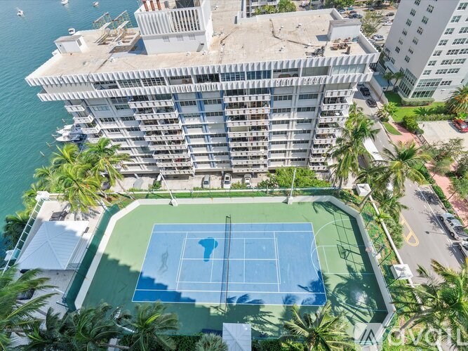 A tennis court is located on the roof of a building.