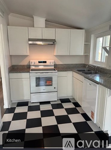 A kitchen with black and white checkered floor.