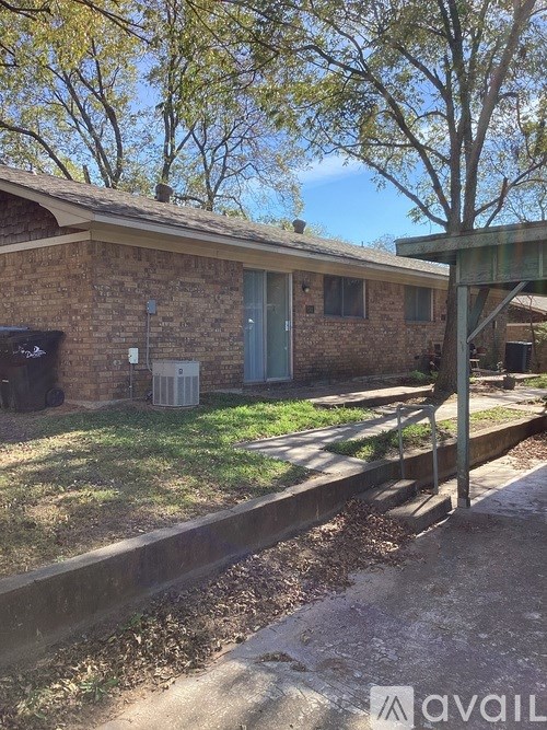 A house with a brown brick exterior and a green door.