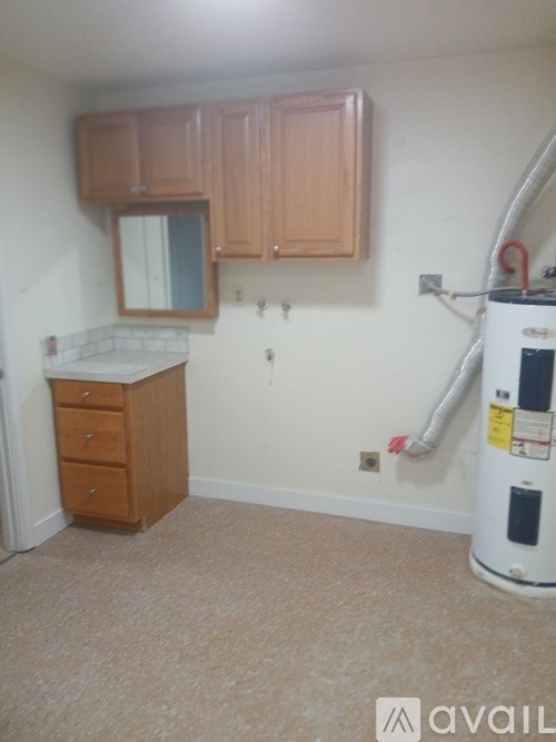 A kitchen with wooden cabinets and a white countertop.