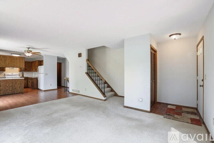 A spacious living room with a staircase leading to the upper floor.