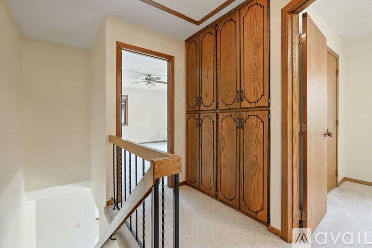 A room with a staircase and a cabinetry unit.