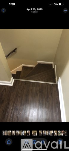 A staircase with wooden steps and white railings.