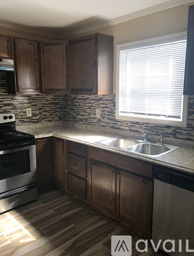 A kitchen with wooden cabinets and a stove top oven.