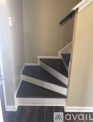 A staircase with a black and white step.