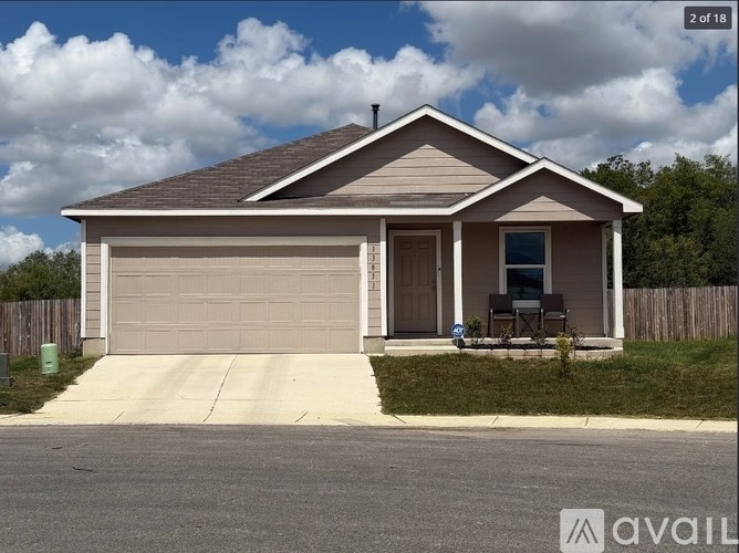 A two-car garage with a brown door and a small porch.