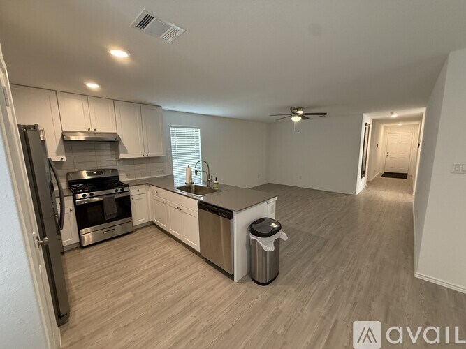 A kitchen with a refrigerator, stove, and oven.