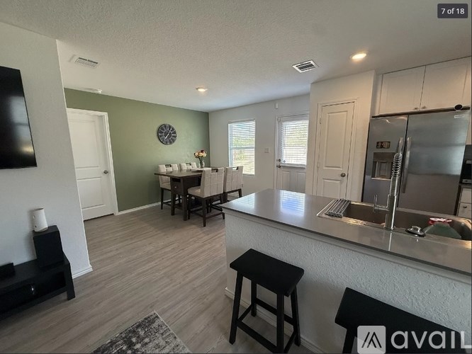 A kitchen with a bar stool and a counter top.