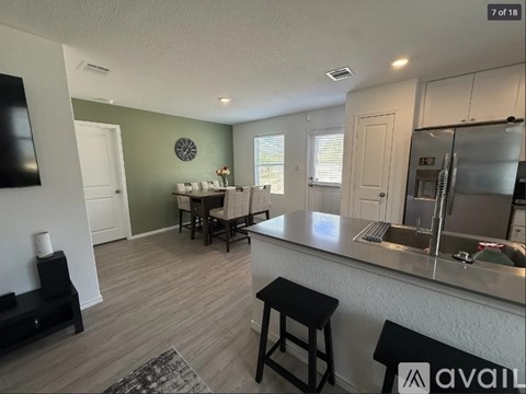 A kitchen with a bar stool and a counter top.