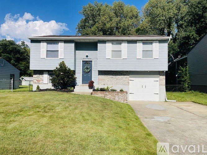 A two-story house with a garage is for sale.